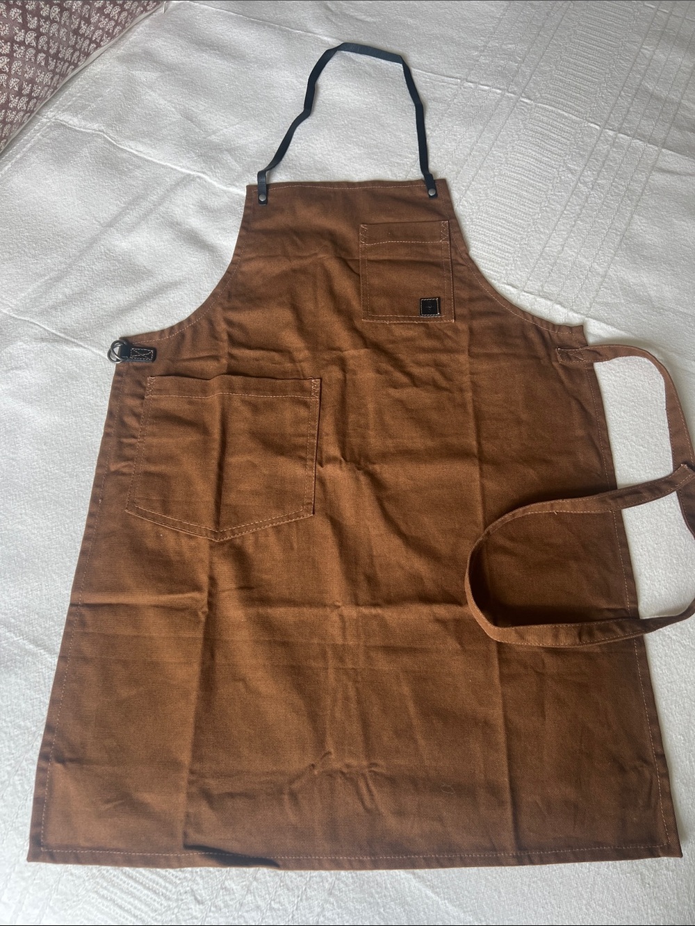 Brown Canvas Utility Apron with Pockets.  Body 100 % Cotton and leather trim.
